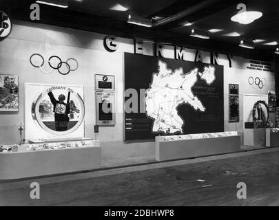 'Stand of the Deutsche Reichsbahn at the London Motor Show with a map of the planned motorway network ( with special marking of sections that have already been built, sections that are under construction, and sections that have just been proposed) in Germany and advertising for the 1936 Winter Olympics in Garmisch-Partenkirchen. To the left and right of the motorway network map there are boards of BMW, Auto Union and Mercedes-Benz. Above, next to the headline ''Germany'' on the right, is the address of the '' German Railways. Information Bureau. 14 Regent Street London''.' Stock Photo