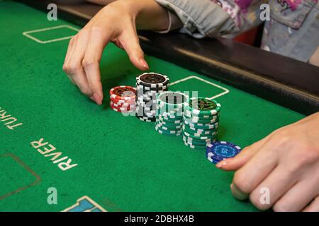 Poker game, the player is counting the chips on the table Stock Photo