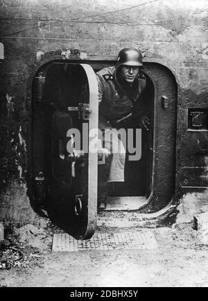 'This photograph of a Wehrmacht soldier in a bunker on the Siegfried Line was published in several German newspapers. The reports on the ''Siegfried Line'' were intended to reduce the population's fear regarding an imminent war on two fronts.' Stock Photo