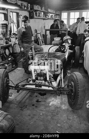 Teen-aged boys meet in a garage to work on a homemade hot rod built from the chassis of an ancient Model T Ford and parts of a Cadillac, a Lincoln and two other Ford automobiles, New York, 1955. (Photo by United States Information Agency/RBM Vintage Images) Stock Photo