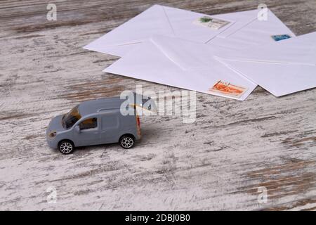 Toy delivery car on rustic wooden floor. Stock Photo