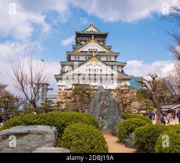 OSAKA, JAPAN- APRIL, 2019: Tourists walking around the Osaka Castle (Osaka-jo) Main tower. It is one of the most famous Japanese castle located in Chu Stock Photo