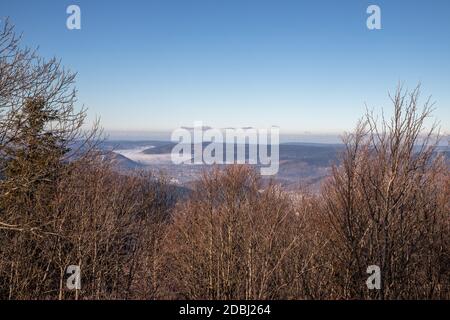 View over the Moselle valley in the fog from the Alsace Belchen Stock Photo