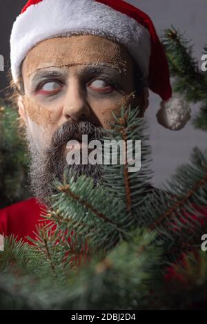 christmas portrait of scary zombie santa dead man. New year horror concept. Halloween Zombie Santa Stock Photo