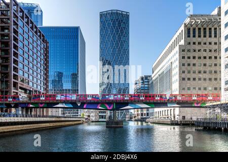 Dockland Light Railway (DLR) train crossing Middle Dock at Canary Wharf, Docklands, London, England, United Kingdom, Europe Stock Photo