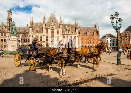 Horse drawn carriage in The Markt (Market Square), Bruges, UNESCO World Heritage Site, West Flanders, Belgium, Europe Stock Photo