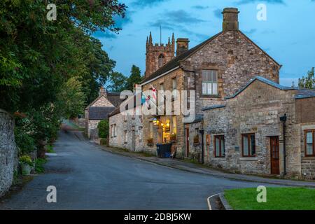 View of village houses and St. Giles' Church at dusk, Hartington, Peak District National Park, Derbyshire, England, United Kingdom, Europe Stock Photo