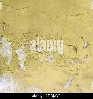 Peeled yellow wall. Ideal for textures or backgrounds. Stock Photo