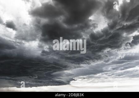 Supercell thunderstorm. Dramatic black clouds and motion. Dark sky with thunderstorm before rainy. Stock Photo