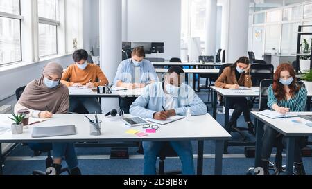 Diverse group of international students studying in classroom Stock Photo