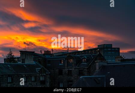 Leith, Edinburgh, Scotland, United Kingdom, 17th November 2020. UK Weather: A fiery orange sunset over the rooftops of tenements, and the council housing estate nicknamed the 'Banana Flats' due its shape but officially known as Cables Wynd House, which featured in Irvine Welsh's book Trainspotting Stock Photo