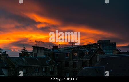 Leith, Edinburgh, Scotland, United Kingdom, 17th November 2020. UK Weather: A fiery orange sunset over the rooftops of tenements, and the council housing estate nicknamed the 'Banana Flats' due its shape but officially known as Cables Wynd House, which featured in Irvine Welsh's book Trainspotting Stock Photo