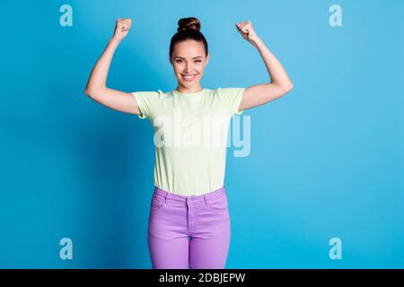 Portrait of her she nice attractive pretty lovely glad cheerful cheery girl demonstrating strong biceps gym visitor self esteem isolated over bright Stock Photo