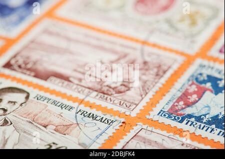 New york, USA - November 17, 2020: Put stamp on international mail from Europe. France stamp on courier package close up view Stock Photo