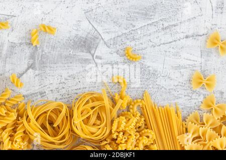 Various pasta on white stone background. View from above. Flat lay. Copy cpase Stock Photo