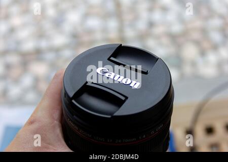Brecht, Belgium - June 20 2020: A portrait of someone holding a canon L lens with a lens cap with the company logo attached to it. Stock Photo