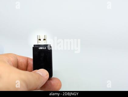 human male hand holding a USB flash memory on a white background. Storage of files and technology Stock Photo