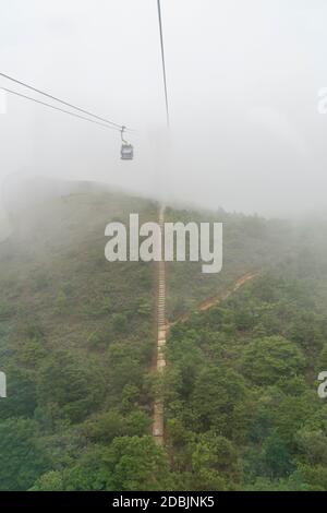 View of the Ngong Ping 360 cable cars going into the cloud, Lantau Island, Hong Kong Stock Photo