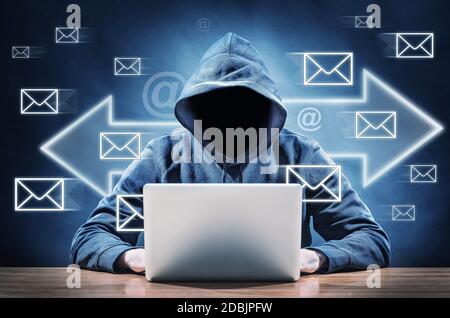 hacker using his computer for spreading spam mails Stock Photo