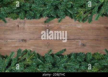 Christmas tree branch borders on wood background. Stock Photo