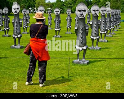 Visitor at the Yorkshire Sculpture Park Wakefield England admiring Black and Blue The Invisible Men and the Masque of Blackness by Zak Ove in 2017 Stock Photo
