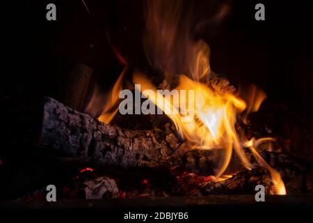 Firewood burning in the fireplace or barbecue.Closeup view.Macro background. Stock Photo