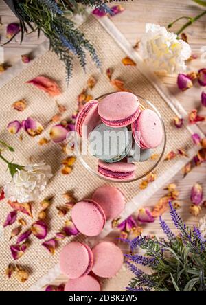 Delicious French macaron cookies in a glass bowl, top view Stock Photo