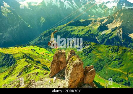 Cable car from Murren to Birg and Schilthorn summit above cliffs, rocky mountains and valleys with lakes and rivers. Snow-capped peaks of Bernese Stock Photo