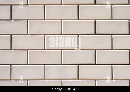 Background from a wall with rectangular beige stone slabs Stock Photo