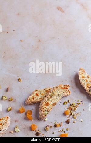 Apricot and pistachio biscotti on a pink marble backdrop Stock Photo