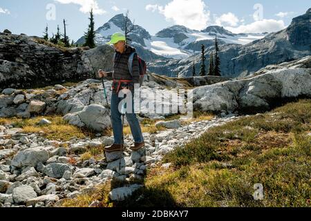 Hiker in alpine meadow, Pemberton, British Columbia, Canada Stock Photo