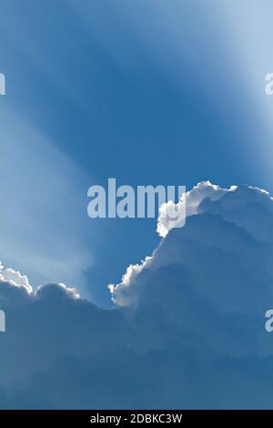 sunlight shining through layers of clouds Stock Photo