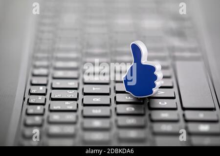 Thumb Up graphic illustration on laptop keyboard Stock Photo