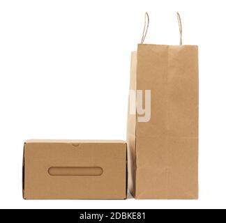 disposable brown craft paper bag with handles and paper box isolated on a white background Stock Photo