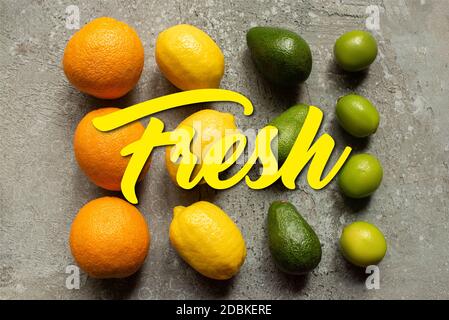 flat lay with colorful oranges, avocado, limes and lemons on grey concrete surface, fresh illustration Stock Photo