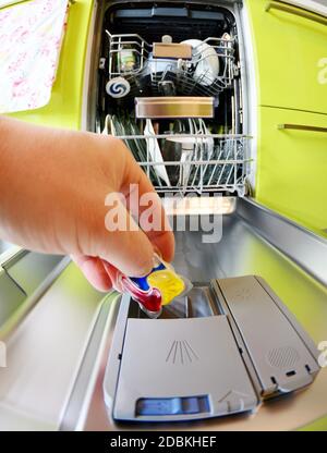 Premium Photo  Close up of hand inserting a capsule into a coffee machine  at home.