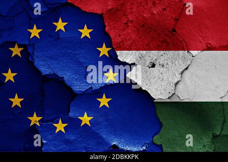 flags of EU and Hungary painted on cracked wall Stock Photo