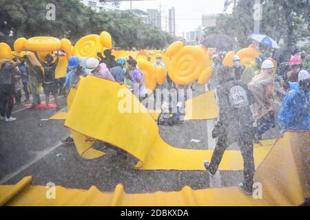 Thailand. 17th Nov, 2020. Pro-democracy protesters run for cover as police fire tear gas and water cannon during a demonstration against a charter amendment at Parliament in Bangkok. (Photo by Vichan Poti/Pacific Press) Credit: Pacific Press Media Production Corp./Alamy Live News Stock Photo