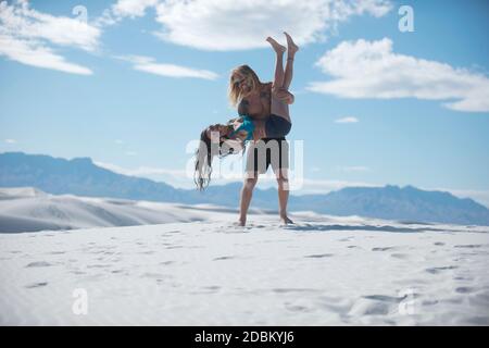 Happy couple having fun in desert, White Sands National Monument, New Mexico, USA Stock Photo