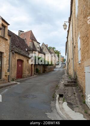 Domme, France - September 5, 2018: Old stone house with wooden shutters ...