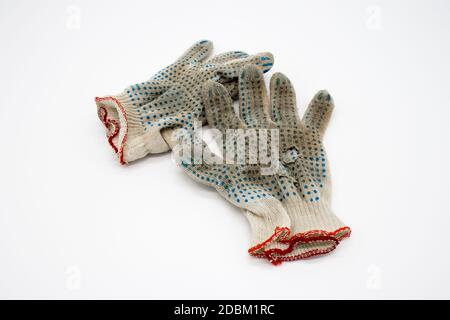 Worn, torn gloves on a white background Stock Photo