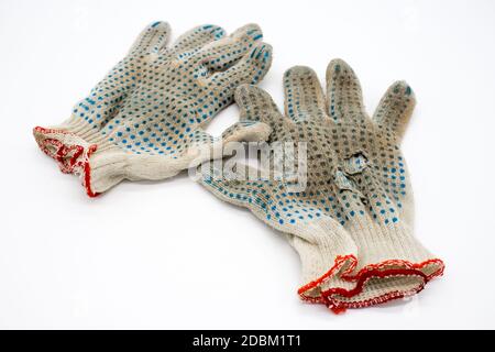Worn, torn gloves on a white background Stock Photo
