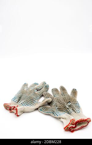 Worn, torn gloves on a white background Stock Photo