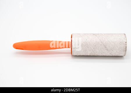 Cleaning sticky roller with orange handle on white background Stock Photo