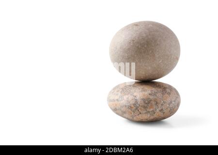 Pyramid of round stones isolated on white background Stock Photo