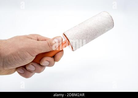 Cleaning sticky roller with orange handle on white background Stock Photo