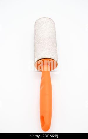 Cleaning sticky roller with orange handle on white background Stock Photo