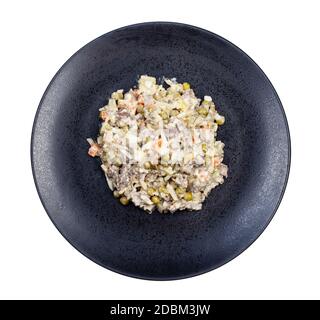 top view of portion of russian Olivier salad on black plate isolated on white background Stock Photo