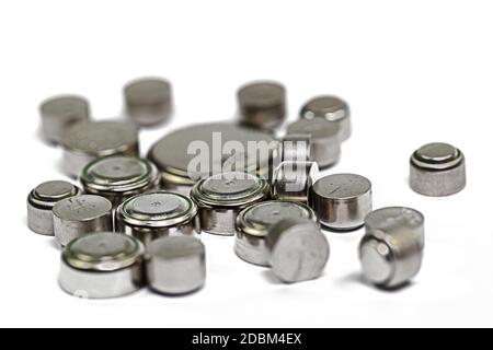 Various button cells against a white background Stock Photo