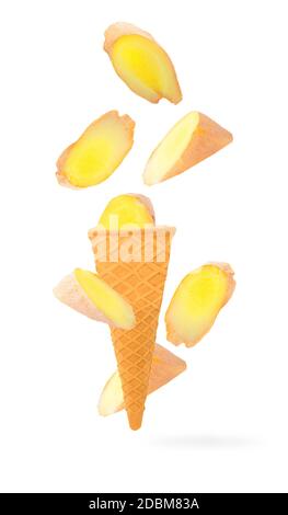 Isolated ice cream cone with fruits in the air. Falling cut ginger isolated on white background with clipping path as package design element and adver Stock Photo